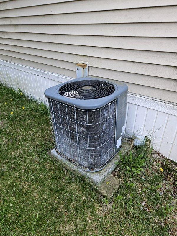 Performed preventive maintenance on 2005 R22 air conditioning system. System pressures measured within acceptable range with an 18-degree temperature differential across the evaporator coil. Capacitor and contactor tested and confirmed operating within manufacturer specifications. Condenser coil manually cleaned using brush method due to non-functional water supply at property; coil condition was relatively clean prior to service. Recommended system replacement due to obsolete R22 refrigerant, but customer declined at this time. Unit operating properly with no additional concerns noted.