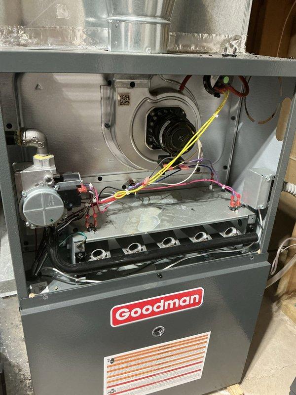 Responded to no cooling call on 23-year-old Goodman air conditioning system. Found frozen refrigerant lines at outdoor condenser unit and confirmed system was low on R22 refrigerant. Advised customer that R22 is no longer stocked due to phase-out regulations and recommended contacting a service provider who still services legacy refrigerant systems. System was shut down to prevent compressor damage from continued operation while frozen. Documented equipment condition with photos of outdoor condenser unit and indoor furnace components.