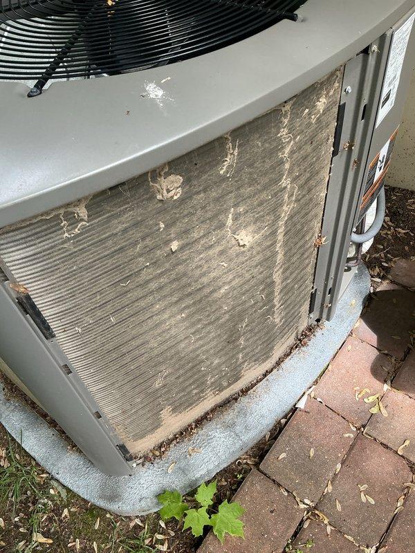 Completed comprehensive AC maintenance tune-up on 6-year-old system per maintenance agreement. Outdoor condenser coil was heavily soiled with organic debris, leaves, dirt, and plant matter; thoroughly cleaned coil fins to restore proper airflow and heat transfer efficiency. System operational with no additional concerns noted.