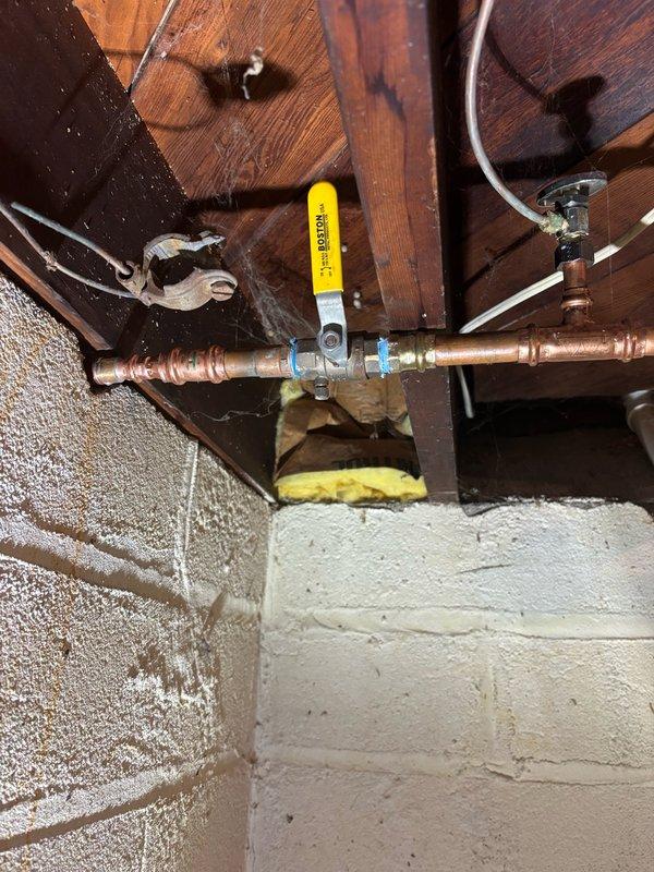 Responded to a water leak emergency caused by a frozen and damaged frost-free outside faucet. Upon arrival, located the backyard spigot connection in the basement where active leaking from the faucet body was observed when the valve was opened. Removed the failed frost-free faucet and installed a new replacement unit, utilizing press connections to secure the new fixture to the existing copper water line. Restored water supply and conducted a thorough leak test by running water through the system for several minutes. Verified all connections were watertight with no signs of leakage at the faucet body or press fittings. Completed exterior sealing around the faucet penetration, cleaned the work area, and left the new frost-free faucet fully operational and in service.