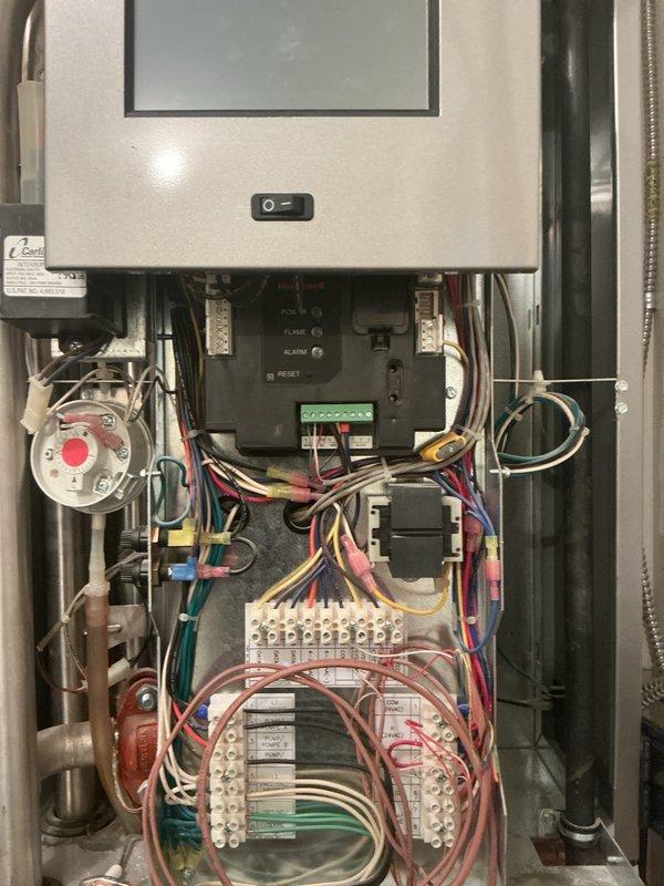 Responded to no heat call on 10-year-old boiler system displaying 109 ignition error code. Upon inspection, diagnosed multiple failed components including main control board, malfunctioning touchscreen interface, and failed automatic air vent. System was unable to provide heat to building or hot water to side arm tank. Documented extensive electrical wiring configuration and hydronic piping arrangement with zone valves and control relays. Presented customer with options for complete system replacement versus comprehensive repair of all failed components due to age of equipment and extent of necessary repairs.
