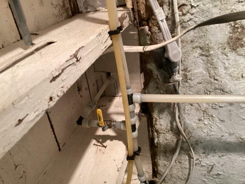 Responded to service call for water heater producing excessively hot water. Performed diagnostic inspection of tanked water heater system in basement utility area, examining temperature and pressure relief valve, thermostat settings, and overall unit condition. Assessed aging water heater installation with deteriorating infrastructure including corroded piping and gas shutoff valve. Inspected exterior hose bibb for potential replacement needs. Provided comprehensive estimate for new water heater installation and hose bibb replacement to address safety concerns and prevent scalding water issues.