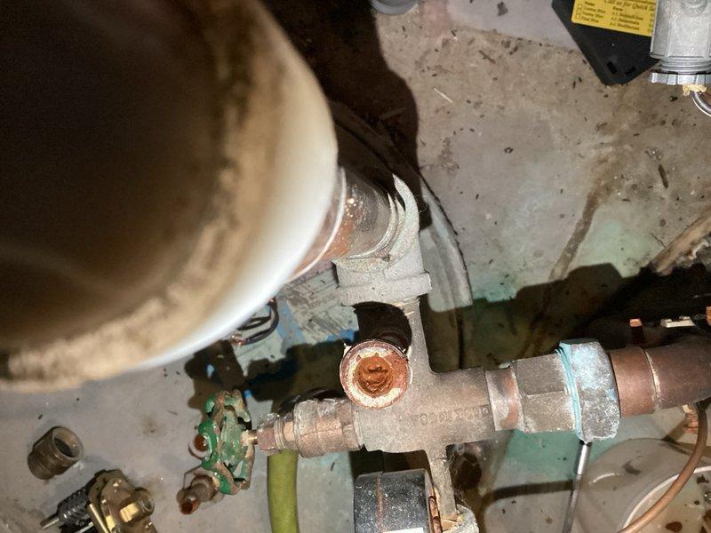 Replaced failed pressure switch on well pump system after discovering the existing switch and nipple were completely obstructed with heavy sediment buildup. Cleared the clogged switch nipple to restore proper water flow and installed new 40-60 PSI pressure switch compatible with existing submersible well pump connections. The new switch is factory-set to signal pump start at 40 PSI and stop at 60 PSI. Documented extensive mineral deposits and corrosion throughout the system components. Advised that if sediment issues continue, replacement of the pressure tank and tank tee assembly may be necessary to prevent future failures.