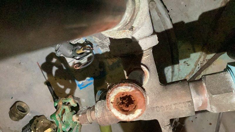 Replaced failed pressure switch on well pump system after discovering the existing switch and nipple were completely obstructed with heavy sediment buildup. Cleared the clogged switch nipple to restore proper water flow and installed new 40-60 PSI pressure switch compatible with existing submersible well pump connections. The new switch is factory-set to signal pump start at 40 PSI and stop at 60 PSI. Documented extensive mineral deposits and corrosion throughout the system components. Advised that if sediment issues continue, replacement of the pressure tank and tank tee assembly may be necessary to prevent future failures.