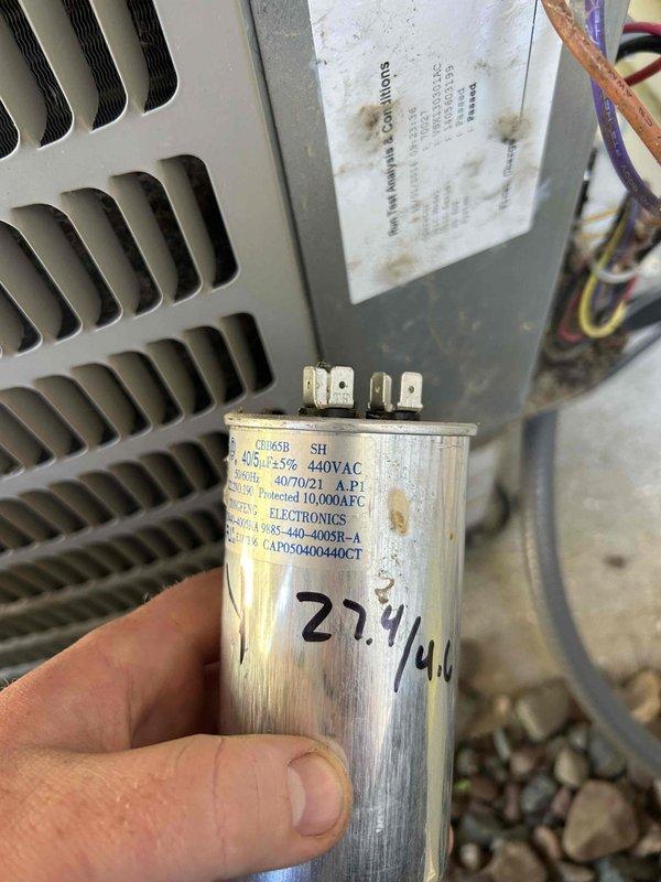 Performed air conditioning tune-up on outdoor condensing unit and identified dual-run capacitor measuring out of specification on both fan and compressor terminals. System maintained acceptable 22° temperature split across evaporator coil, and all other components operated within normal parameters. Documented equipment specifications with photographs and provided estimate for capacitor replacement to customer.