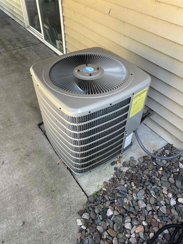 Performed air conditioning tune-up on outdoor condensing unit and identified dual-run capacitor measuring out of specification on both fan and compressor terminals. System maintained acceptable 22° temperature split across evaporator coil, and all other components operated within normal parameters. Documented equipment specifications with photographs and provided estimate for capacitor replacement to customer.
