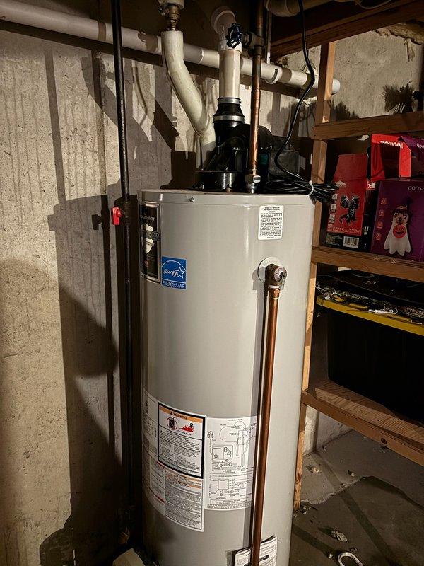 Responded to service call for water heater producing insufficient hot water and leaking from bottom of unit. Upon inspection, determined existing tanked water heater had failed and was actively leaking at base, creating moisture on basement floor. Removed and disposed of failed unit. Installed new 50-gallon natural gas power vent water heater with Energy Star certification. Connected all copper supply lines, gas line, and PVC vent piping. Installed circulation pump and necessary valves. Tested all connections for leaks, verified proper venting, and confirmed unit operation with adequate hot water production throughout home.