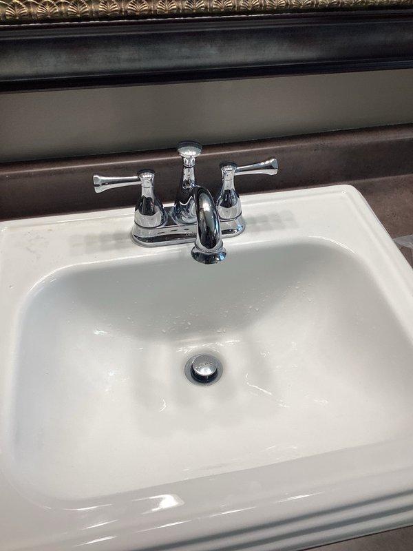 Responded to service call for multiple faucet issues including two leaking Delta bathroom faucets and reduced hot water flow in kitchen faucet. Replaced hot and cold cartridges in both lavatory faucets to resolve leaking issues. Kitchen faucet diagnosed with clogged aerator or filter restricting hot water flow on that side only.