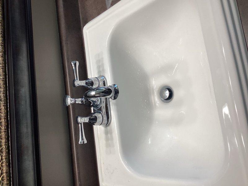 Responded to service call for multiple faucet issues including two leaking Delta bathroom faucets and reduced hot water flow in kitchen faucet. Replaced hot and cold cartridges in both lavatory faucets to resolve leaking issues. Kitchen faucet diagnosed with clogged aerator or filter restricting hot water flow on that side only.