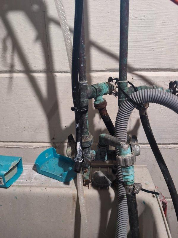 Replaced corroded and seized laundry washing machine shut-off valves with new valves for both hot and cold water supply lines. The existing valves had deteriorated and would not turn to shut off water flow. After installation, restored water supply and performed a 10-minute leak inspection to verify proper operation before returning the system to service.