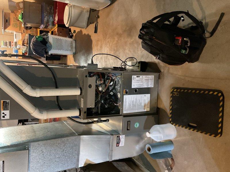 Completed comprehensive BOGO tune-up on both air conditioning and furnace systems, performing diagnostic testing through S40 system, washing condenser coil, and inspecting all components. Identified ongoing refrigerant migration issue causing gurgling sound for approximately one minute, determined to be caused by improper refrigerant line routing installed three years ago; recommended follow-up visit to install 90° bends in exterior refrigerant lines to resolve vibration and migration concerns. All other system components tested within normal operating parameters.