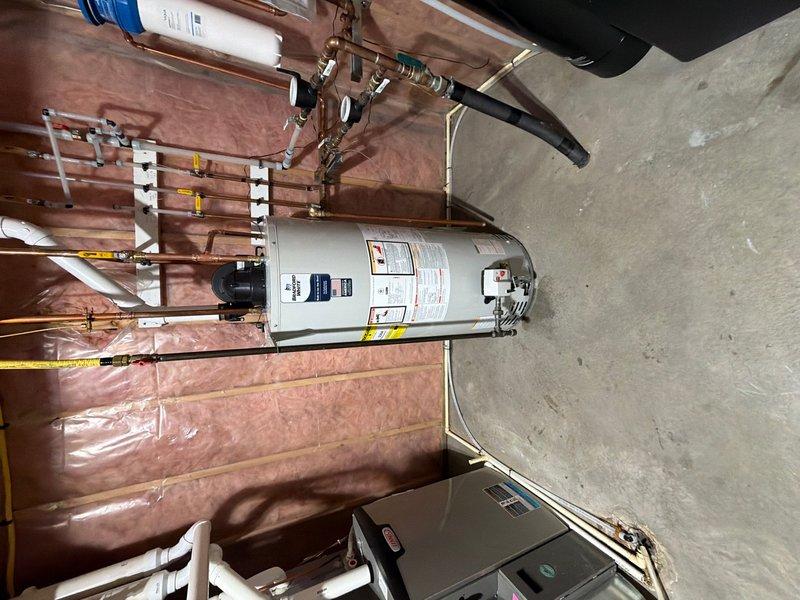Completed installation of a 50-gallon power vent water heater in the utility room. Connected all copper supply lines with proper fittings and valves, installed power vent exhaust system with PVC piping, and secured unit to manufacturer specifications. All plumbing connections were tested and verified leak-free, electrical connections completed, and system is fully operational.