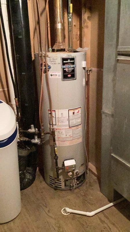 Performed comprehensive operational inspection of natural gas tanked water heater and water softener system in residential basement utility area. Verified proper function of all water heater components including burner assembly, venting system, temperature controls, and pressure relief valve. Checked water softener operation and confirmed adequate system performance. Provided detailed estimate for replacement of existing unit with 50-gallon standard vent natural gas water heater, including specifications for proper venting requirements and installation parameters. Documented existing equipment configuration with copper supply lines, control panel functionality, and current installation setup. All systems found operational at time of inspection.