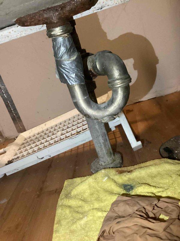 Performed complimentary estimate for laundry tub sink replacement due to recurring clogging issues. Inspected existing aging metal P-trap assembly showing significant wear and oxidation, with temporary tape repairs on drain piping. Provided multiple options including full fixture replacement and alternative removal of existing tub to address drainage concerns.