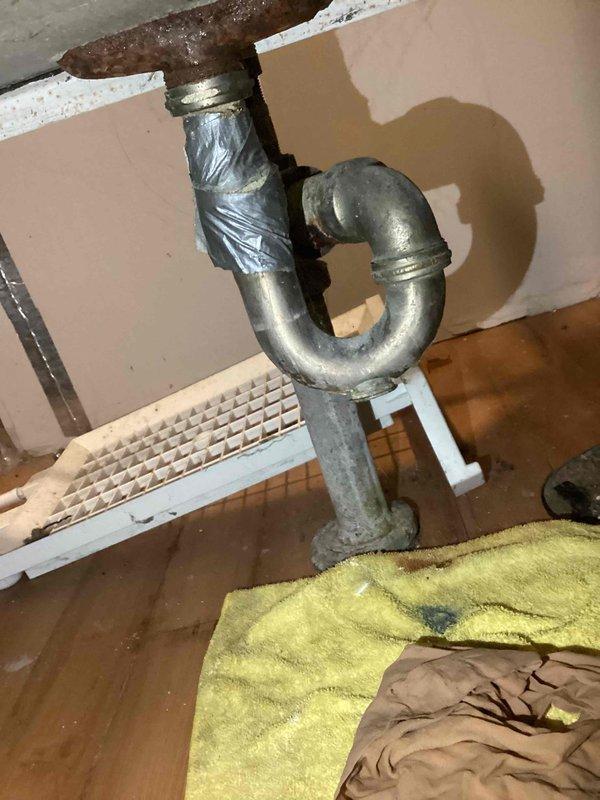 Performed complimentary estimate for laundry tub sink replacement due to recurring clogging issues. Inspected existing aging metal P-trap assembly showing significant wear and oxidation, with temporary tape repairs on drain piping. Provided multiple options including full fixture replacement and alternative removal of existing tub to address drainage concerns.