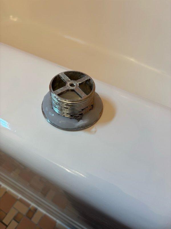 Responded to a bathtub drain leak caused by a cross-threaded and improperly sealed tub shoe. Removed the defective drain shoe and pop-up assembly, then installed new components with proper threading and silicone sealing. Tightened all connections and conducted a 10-minute water test by filling the tub and running water to verify complete leak elimination. No leaks were detected in the basement below. Fixture restored to full service.