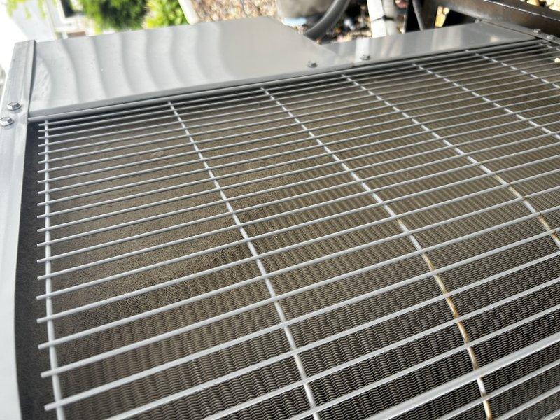 Responded to no cooling complaint on 9-year-old residential HVAC system. Upon arrival, customer was not home; accessed property using provided garage code. Diagnosed failed capacitor on outdoor condensing unit preventing compressor operation. Noted moderate debris accumulation on condenser coil and dirty air filter at indoor unit. Contacted customer for approval and proceeded with capacitor replacement, condenser coil cleaning, and air filter replacement. Verified proper system operation upon completion with normal cooling cycle, appropriate amperage draw, and correct temperature split across evaporator coil.