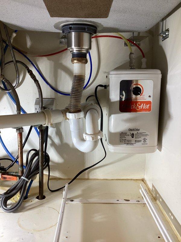 Responded to water leak under kitchen sink. Upon inspection, identified multiple leak sources including deteriorated P-trap connections, failing sink basket assembly, and compromised nylon sealing rings. Disassembled drain assembly and cleaned all connection points. Replaced worn nylon compression rings at P-trap joints, installed new sink basket with proper plumber's putty seal, and replaced defective water supply stop valve in yard to address secondary leak concern. Tested all connections under pressure to verify leak-free operation. System restored to full functionality.