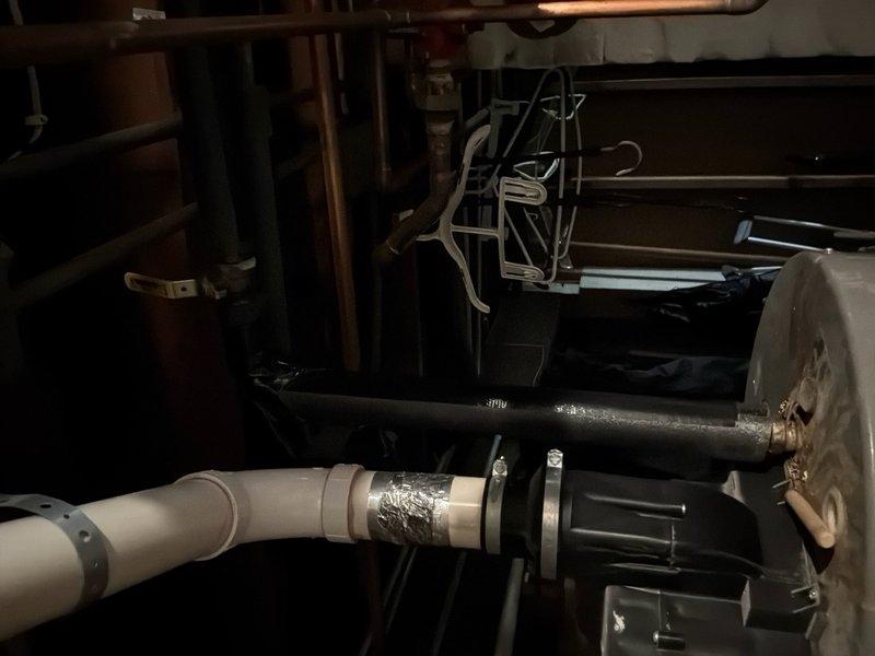 Responded to service call for leaking water heater. Upon inspection, identified active leak originating from bottom of tank on approximately 8-year-old unit. Documented existing conditions with photographs of equipment and surrounding mechanical space. Advised customer that bottom tank leaks indicate internal tank failure and require full water heater replacement rather than repair. Provided estimate for replacement installation.
