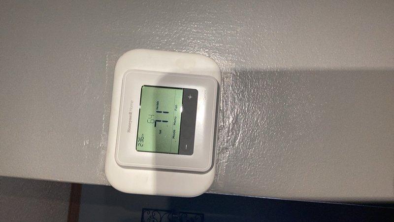Responded to callback for AC system fan continuing to run after reaching setpoint temperature. Replaced thermostat and monitored system operation for approximately 20 minutes to verify proper cycling. Fan shut down within one minute after cooling call ended, indicating improved performance. Documented control board model number and captured photos for reference, as intermittent relay sticking on control board remains possible cause if issue recurs.