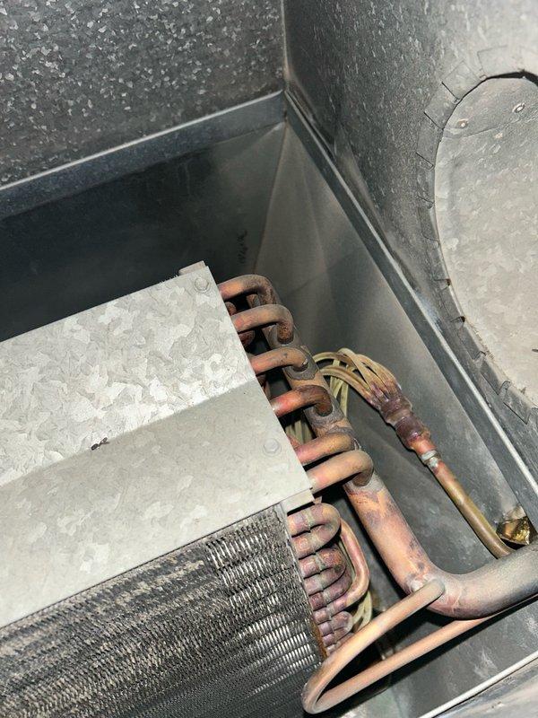 Completed comprehensive AC tune-up and preventative maintenance on single air conditioning unit under PA Membership agreement. Performed full system inspection including thermostat operation verification, filter replacement (16x25x1), blower assembly evaluation, outdoor coil condition assessment, electrical component testing, contactor and capacitor inspection, condensate drain check, refrigerant operation analysis, and temperature split measurements. All readings returned normal values with no mechanical issues or safety concerns identified. System operating within manufacturer specifications with proper cooling output confirmed. Equipment showing age-appropriate wear on copper tubing with visible oxidation and patina, but all components functioning correctly. Recommend continued seasonal maintenance to preserve system efficiency and monitor normal component degradation as unit ages.