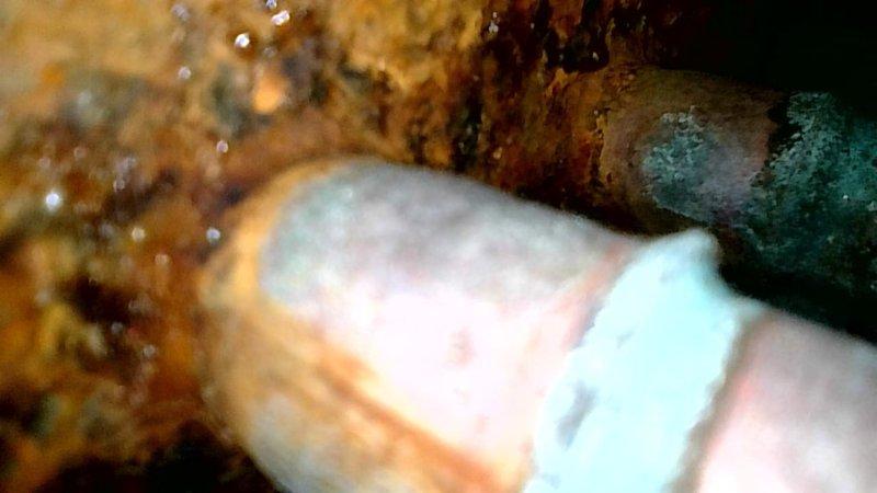 Responded to no cooling complaint on aging R22 system. Upon inspection, found evaporator coil frozen with excessive condensation and visible rust damage. Condenser unit operational but refrigerant charge critically low. Diagnostic readings revealed suction pressure below operational specifications with saturation temperature below freezing point. Measured suction line temperature at 79°F with superheat at 50°F, significantly exceeding the recommended 21°F superheat specification, confirming substantial refrigerant loss. Visual inspection documented heavily corroded evaporator coil with signs of chronic moisture intrusion and active leakage. Due to R22 refrigerant restrictions and inability to perform leak repairs on obsolete systems, recommended complete system replacement. Provided photographic documentation of rusted components and overall unit condition.