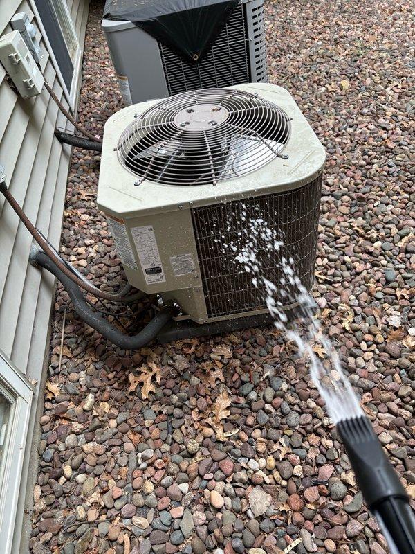 Completed annual air conditioning maintenance and tune-up inspection. Performed comprehensive system check including all electrical components, refrigerant lines, and condenser unit operation. Cleaned condensate drain lines, which were found to be clear and functioning properly. Inspected outdoor unit and removed debris including sunflower seeds from interior; confirmed no wire damage present. Washed condenser coil and verified all system components operating within normal parameters with no issues identified.