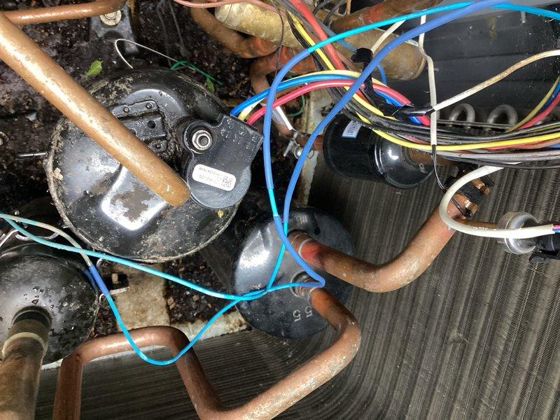 Responded to a warranty repair on an outdoor heat pump unit with rodent-damaged wiring. Upon inspection, found compromised electrical wiring and thermal sensor on the compressor. Replaced the damaged thermal sensor and inspected all electrical connections throughout the unit for additional rodent damage. Re-insulated wiring to the reversing valve solenoid to restore proper protection. Cycled the system through heating and cooling modes to verify proper operation. Checked refrigerant charge and pressures, confirming levels within manufacturer specifications. Unit restored to normal operating condition with all components functioning properly.