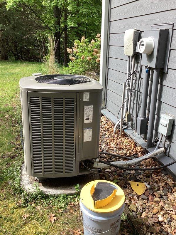 Responded to a warranty repair on an outdoor heat pump unit with rodent-damaged wiring. Upon inspection, found compromised electrical wiring and thermal sensor on the compressor. Replaced the damaged thermal sensor and inspected all electrical connections throughout the unit for additional rodent damage. Re-insulated wiring to the reversing valve solenoid to restore proper protection. Cycled the system through heating and cooling modes to verify proper operation. Checked refrigerant charge and pressures, confirming levels within manufacturer specifications. Unit restored to normal operating condition with all components functioning properly.