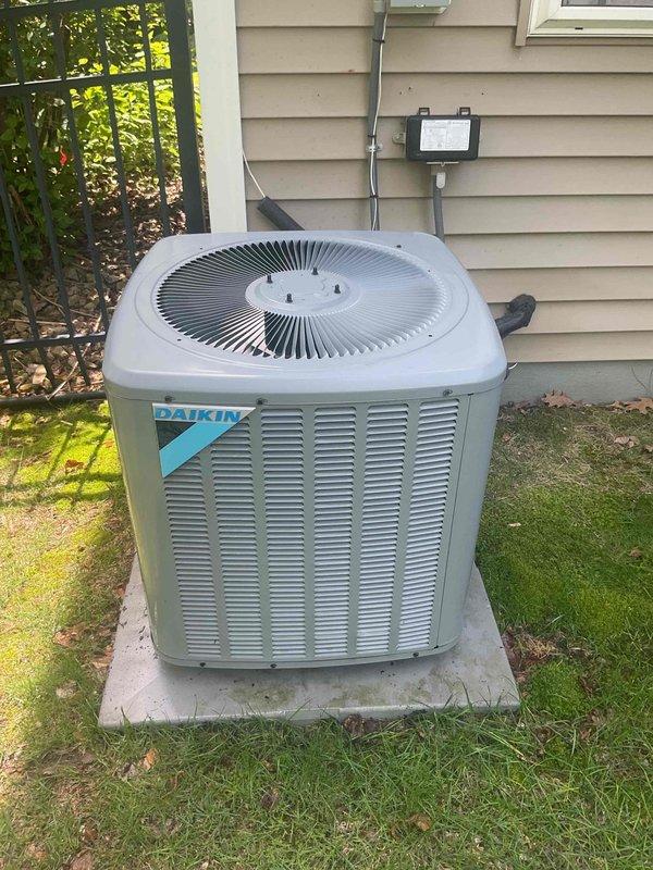 Performed comprehensive AC tune-up on 7-year-old Daikin split system. Inspected indoor furnace unit and outdoor condensing unit, verified proper operation of all components including copper refrigerant lines, manifold connections, and red-handled service valves. Checked electrical connections at outdoor disconnect, confirmed adequate airflow through condenser coils and fan assembly, and verified system is operating within manufacturer specifications. System found to be functioning properly with no issues identified during maintenance inspection.
