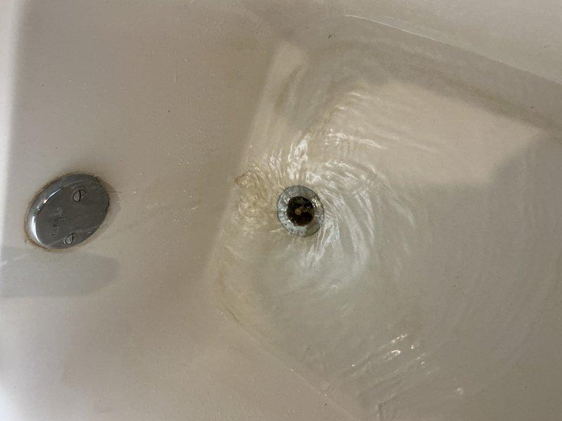 Responded to upstairs bathtub with slow drainage issue that had progressively worsened over time. Upon inspection, identified partial blockage in drain line restricting water flow. Utilized plunger to clear obstruction and restore proper drainage function. Applied chemical drain cleaner to remove remaining buildup and prevent future blockages. Tested drainage system to verify full water flow restoration. Bathtub now draining at normal rate with no additional plumbing issues detected in surrounding fixtures.