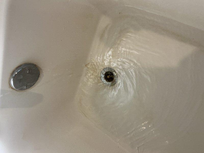Responded to upstairs bathtub with slow drainage issue that had progressively worsened over time. Upon inspection, identified partial blockage in drain line restricting water flow. Utilized plunger to clear obstruction and restore proper drainage function. Applied chemical drain cleaner to remove remaining buildup and prevent future blockages. Tested drainage system to verify full water flow restoration. Bathtub now draining at normal rate with no additional plumbing issues detected in surrounding fixtures.