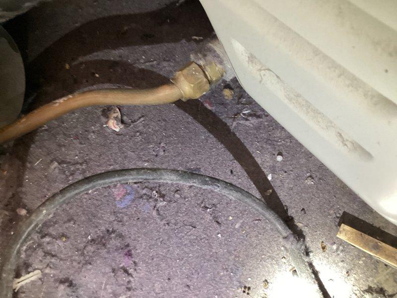 Responded to a gas line issue behind a dryer where the rigid copper piping had become kinked due to appliance movement. The original installation lacked a flexible appliance connector, causing the copper line to sustain damage when the dryer was repositioned. 

Removed the damaged section of copper gas line and rerouted the supply line through the stud wall for proper installation. Secured the copper piping and installed a ball valve at the connection point for safety and future service access. Connected a flexible gas appliance whip from the wall outlet to the dryer, replacing the previously damaged rigid copper configuration.

Performed complete leak check on all connections using approved testing methods and verified safe operation of the appliance. The installation now meets code requirements with proper flexible connector to prevent future damage during appliance movement.