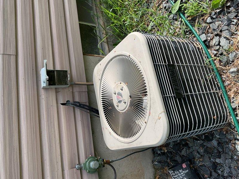 Responded to no-cool call on 26-year-old central air conditioning system. Upon inspection, discovered rodent damage to electrical wiring and a failed relay preventing compressor operation. Fan capacitor tested out of specification. Completed temporary repairs to restore system operation by replacing damaged wiring and relay, allowing unit to run until full system replacement can be scheduled.