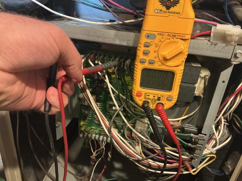 Responded to no cooling complaint on 23-year-old HVAC system with no thermostat signal. Upon arrival, performed diagnostic testing with multimeter on furnace control board and confirmed complete failure of low voltage relay circuit to thermostat and outdoor AC unit. Control board failure likely caused by compressor short circuit during AC startup attempt, compounded by age-related component degradation. System unable to provide heating or cooling functionality. Documented electrical panel configuration and captured diagnostic testing of failed control board showing no voltage output. Due to age of equipment and extent of failure, recommended full system replacement rather than repair. Coordinated same-day estimate appointment for new furnace and air conditioning installation.