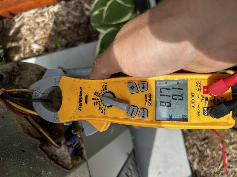 Responded to no cooling complaint on 19-year-old air conditioning system. Upon arrival, verified thermostat call for cooling and inspected indoor unit. Found air filter in acceptable condition and tested blower motor capacitor, which measured 30% below rated specifications. Proceeded to outdoor condensing unit and connected refrigerant gauges to service ports. Diagnostic testing revealed critically low refrigerant charge with near-zero suction pressure readings. Visual inspection of outdoor coil showed significant dirt and debris accumulation on condenser fins. Due to system age and HCFC-22 refrigerant type, recommended customer consultation with service advisor regarding repair versus replacement options, as company policy does not support recharging legacy refrigerant systems.