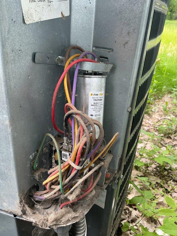 Responded to no cooling call on 15-year-old 2-ton air conditioning system. Upon arrival, verified thermostat was calling for cooling but outdoor unit was not operating. Inspected outdoor disconnect and found both fuses had failed. Replaced failed fuses and restored power to condensing unit. System tested and confirmed operational with proper cooling cycle.

During inspection, identified electrical safety concern: indoor breaker is rated at double-pole 30 amp, which does not match manufacturer specifications for this 2-ton AC unit. Recommended customer contact licensed electrician to evaluate and correct breaker sizing to ensure proper overcurrent protection and code compliance. Also noted significant debris accumulation around electrical components in outdoor unit, including grass and organic material near capacitor and wiring connections.
