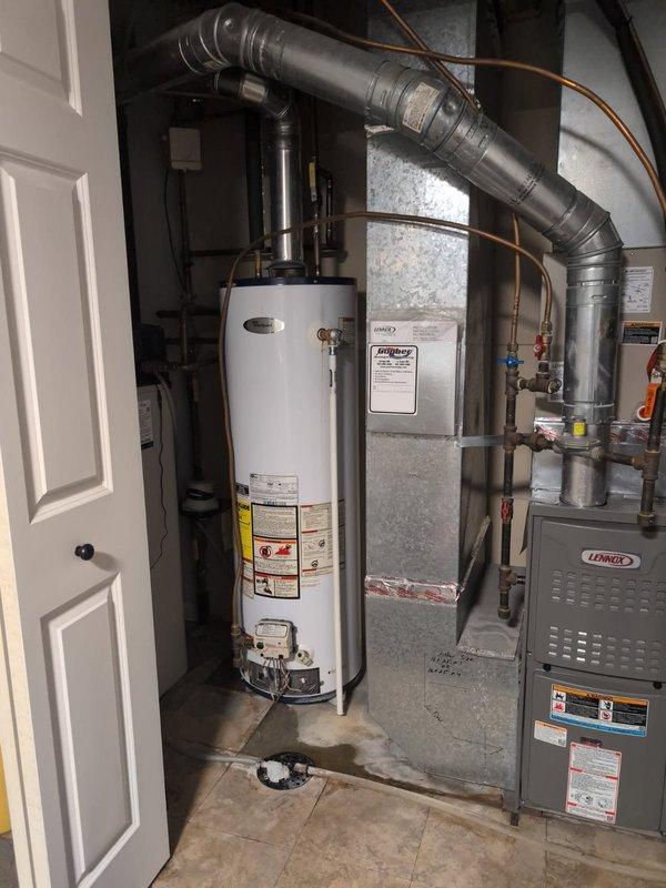 Responded to no hot water complaint at residential property. Upon arrival, found existing Whirlpool N40T61-343 water heater had ceased producing hot water despite pilot light remaining lit. After assessment, determined the unit had reached end of service life and was not economical to repair. Removed and properly disposed of old 40-gallon tanked water heater. Installed new 40-gallon gas-fired residential water heater in basement mechanical room. Connected copper supply lines via soldered connections to match existing plumbing configuration without threaded unions. Installed new temperature and pressure relief valve with proper discharge piping. Connected gas supply line and flue venting to manufacturer specifications. Tested all connections for leaks, verified proper combustion and venting operation, and confirmed hot water delivery to fixtures throughout home. Unit left in full operational condition.