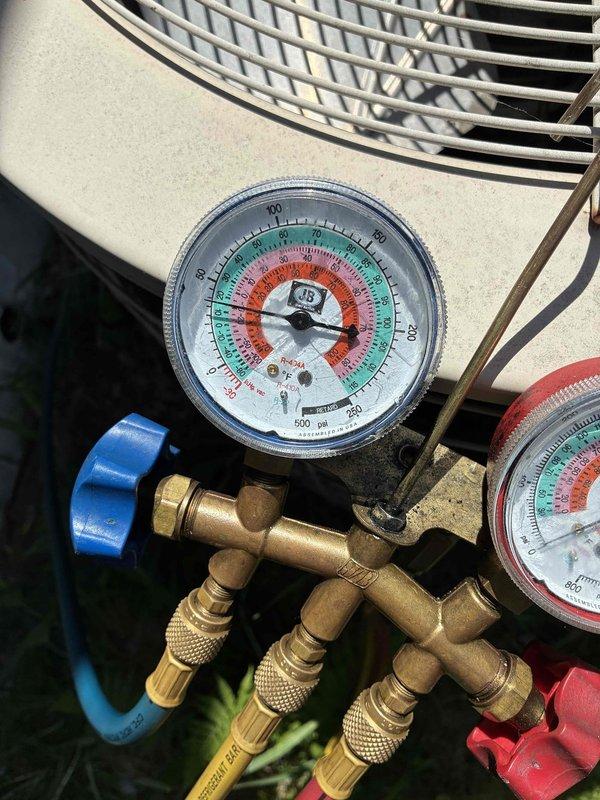 Responded to no cooling complaint on 1993 R-22 air conditioning system. Unit was running but not producing cold air. Connected manifold gauges and recorded 45 psi static pressure and approximately 5 psi suction pressure during operation, indicating significant refrigerant undercharge. Performed leak inspection at refrigerant line connections that were recently disturbed during furnace replacement in December, finding no evidence of oil residue or active leaks at those fittings. Discussed system age and obsolescence with homeowner, noting the unit is over 30 years old and uses R-22 refrigerant which has been phased out. Explained that given the system's age and current refrigerant technology, replacement would be more cost-effective than repair. Offered complimentary estimate for new system installation, but homeowner declined and indicated preference for window units instead. No repairs performed at customer's request. Documented conditions with photos showing gauge readings and outdoo