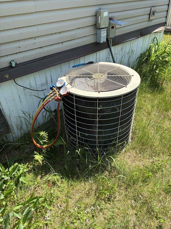 Responded to no cooling complaint on 1993 R-22 air conditioning system. Unit was running but not producing cold air. Connected manifold gauges and recorded 45 psi static pressure and approximately 5 psi suction pressure during operation, indicating significant refrigerant undercharge. Performed leak inspection at refrigerant line connections that were recently disturbed during furnace replacement in December, finding no evidence of oil residue or active leaks at those fittings. Discussed system age and obsolescence with homeowner, noting the unit is over 30 years old and uses R-22 refrigerant which has been phased out. Explained that given the system's age and current refrigerant technology, replacement would be more cost-effective than repair. Offered complimentary estimate for new system installation, but homeowner declined and indicated preference for window units instead. No repairs performed at customer's request. Documented conditions with photos showing gauge readings and outdoo