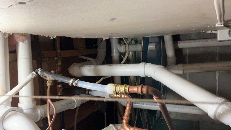 Responded to emergency water heater failure with active leak causing floor damage. Provided estimate options for both standard atmospheric vent and power vent configurations on 40-gallon natural gas water heater replacement. Customer selected power vent option. Removed failed standard vent water heater and installed new 40-gallon natural gas power vent unit. Reconfigured venting system by removing existing metal vent pipe and installing new PVC vent piping to accommodate power vent exhaust requirements. Completed all necessary gas line connections, water supply piping with copper and PVC materials, and verified proper operation of new power vent water heater system.