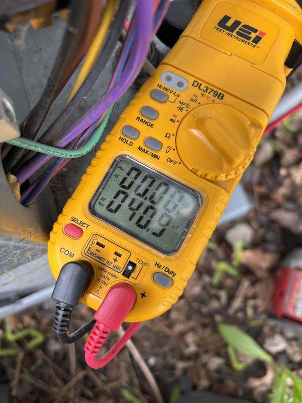 Responded to no cooling complaint on residential air conditioning system. Upon arrival, found outdoor unit not receiving 24-volt power supply. Traced electrical issue to tripped GFCI outlet caused by failed condensate pump that was full of water. Reset GFCI and confirmed condensate pump resumed operation, restoring power to outdoor unit.

Performed system diagnostics and measured temperature split at only 13 degrees, indicating inadequate cooling performance. Checked refrigerant pressures and identified elevated head pressure. Inspected outdoor condenser coil and found heavy dirt accumulation restricting airflow. Cleaned condenser coil thoroughly, resulting in refrigerant pressures returning to normal operating range. Rechecked temperature split, which improved to 15 degrees and within acceptable parameters.

Identified additional maintenance items requiring attention: capacitor showing signs of wear and condensate pump at end of service life. Provided estimates for dual-run capacitor 