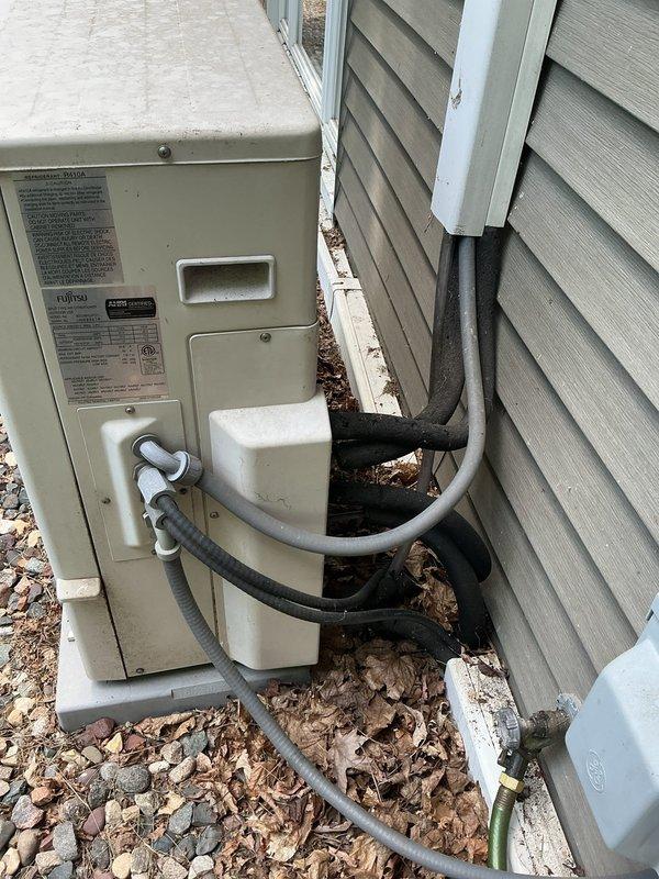 Provided second opinion estimate for 9-year-old Fujitsu Halcyon multi-zone mini split system with three indoor head units. Inspected system after previous contractor diagnosed one head unit as damaged and requiring replacement. Evaluated outdoor condensing unit and indoor evaporator coils, noting significant dust and debris accumulation on accessible head unit's finned coil assembly. Assessed refrigerant line connections and electrical components at both outdoor unit and indoor heads. Prepared estimate for system evacuation, refrigerant recovery, isolation of damaged third head unit, system recharge with approximately 4 pounds of refrigerant, and restoration of cooling operation to remaining two functional head units. Provided separate pricing option for replacement of damaged head unit pending parts availability and sourcing. Documented equipment condition with photographs showing internal components of wall-mounted head unit and exterior condensing unit installation with refrigerant 