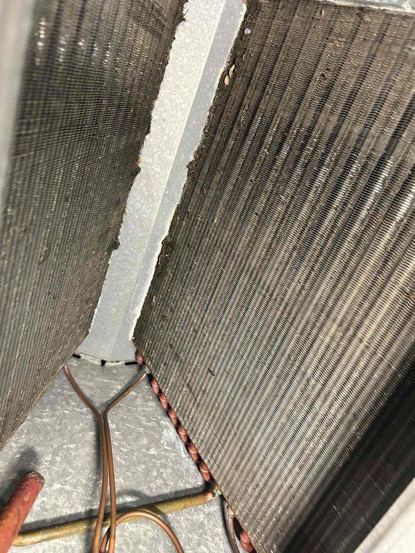 Responded to no-cool complaint on 10+ year old A/C unit that had capacitor replaced previously. Upon arrival, found thermostat set to 80° with ambient temperature below setpoint, preventing system operation. Performed comprehensive system evaluation including visual inspection of evaporator coils and refrigerant lines, verified all components operating properly, and connected manifold gauges to check system pressures. Refrigerant pressures within manufacturer specifications, achieving proper 15° temperature split across evaporator coil with no evidence of icing or airflow restrictions. All mechanical and electrical components functioning as designed. After discussion with homeowner regarding thermostat operation and temperature settings, determined issue was thermostat programming rather than equipment malfunction. System operating normally with no repairs required.