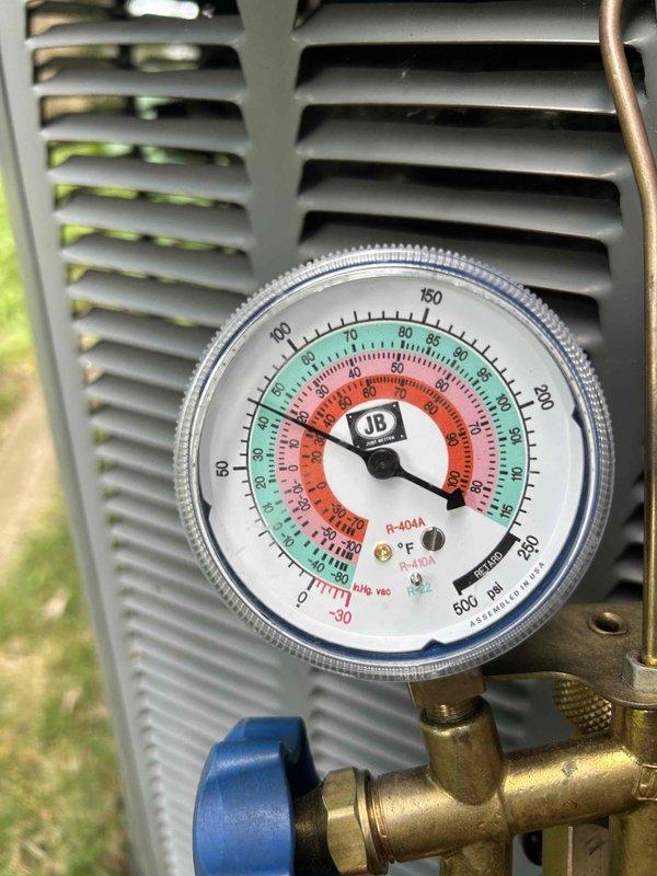 Responded to no-cool complaint on 10+ year old A/C unit that had capacitor replaced previously. Upon arrival, found thermostat set to 80° with ambient temperature below setpoint, preventing system operation. Performed comprehensive system evaluation including visual inspection of evaporator coils and refrigerant lines, verified all components operating properly, and connected manifold gauges to check system pressures. Refrigerant pressures within manufacturer specifications, achieving proper 15° temperature split across evaporator coil with no evidence of icing or airflow restrictions. All mechanical and electrical components functioning as designed. After discussion with homeowner regarding thermostat operation and temperature settings, determined issue was thermostat programming rather than equipment malfunction. System operating normally with no repairs required.