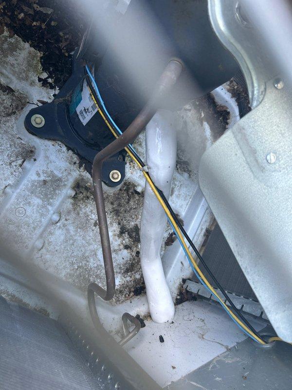 Responded to no cooling complaint on 5-year-old residential AC system. Upon arrival, found evaporator coil and refrigerant line set completely frozen with heavy ice accumulation throughout the air handler compartment. Documented extensive frost buildup on coil, suction line, and drain pan via photographs. System was shut down to allow ice to melt safely. Scheduled follow-up appointment to return once coil has fully thawed to perform refrigerant charge verification, check for airflow restrictions, and diagnose root cause of freezing condition.