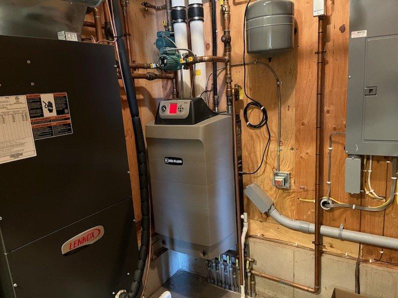 Responded to boiler lockout condition on Weil-McLain unit. Upon arrival, reset system and boiler successfully ignited and ran through initial cycle. Induced second heat call to verify operation, which resulted in ignition failure and subsequent lockout. Diagnosed faulty igniter as cause of intermittent failure. Provided estimate for igniter replacement. Also performed requested AC tune-up during same visit.
