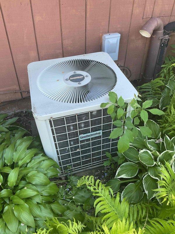 Responded to no cooling complaint on 27-year-old residential air conditioning system. Found evaporator coil severely frozen with active refrigerant leak causing water damage to furnace below. System operating on obsolete R22 refrigerant and losing charge rapidly, freezing up almost immediately upon startup. Due to age of equipment, obsolete refrigerant type, active leak, and risk of continued water damage voiding furnace warranty, recommended full system replacement. Scheduled replacement estimate appointment and advised against further operation to prevent additional damage to furnace unit.