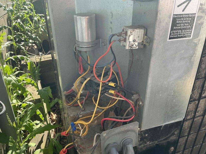 Responded to no cool call on 30-year-old air conditioning system with non-operational outdoor fan. Performed diagnostic testing and discovered low pressure cutout switch in open position, preventing voltage from reaching contactor. Connected manifold gauges to measure static system pressures and confirmed refrigerant undercharge—high side pressure reading approximately 20 degrees below ambient temperature. System operates on R22 refrigerant. Due to age of equipment and refrigerant type, repair options are limited. Coordinated service advisor appointment to discuss replacement options with homeowner.