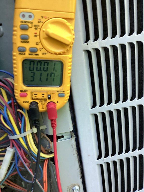Responded to no cooling complaint on 10+ year old air conditioning system with system malfunction error displayed on thermostat. Diagnostic testing revealed failed condenser fan motor, defective run capacitor, and compressor exhibiting abnormal operational sounds indicating potential failure. Replaced condenser fan motor and run capacitor to restore system operation, though compressor condition warrants monitoring for future replacement needs.